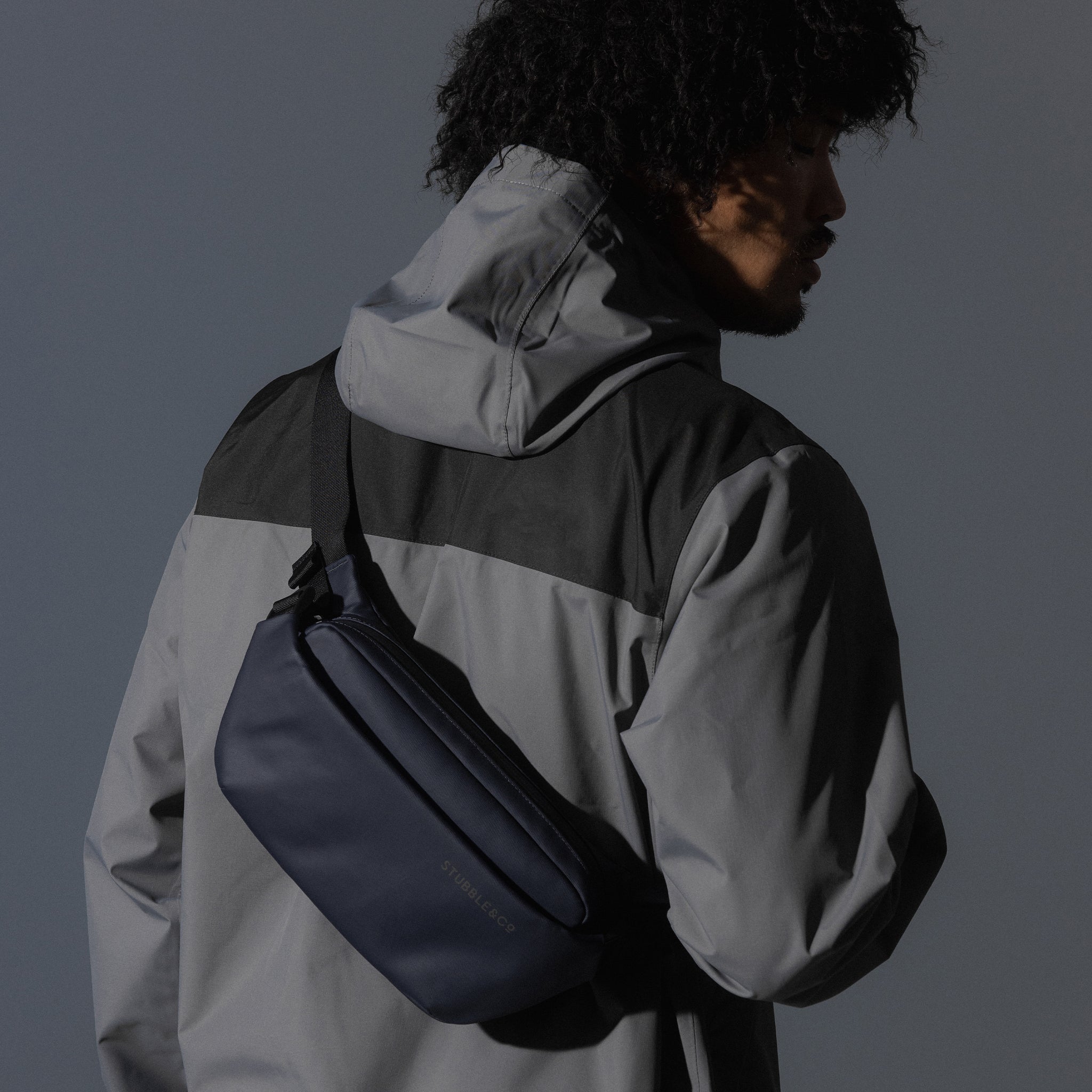 A man wearing a Midnight Blue Crossbody on his back