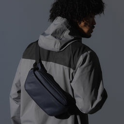 A man wearing a Midnight Blue Crossbody on his back