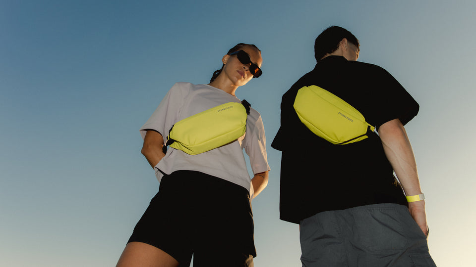 A man and woman wearing Volt crossbody's 