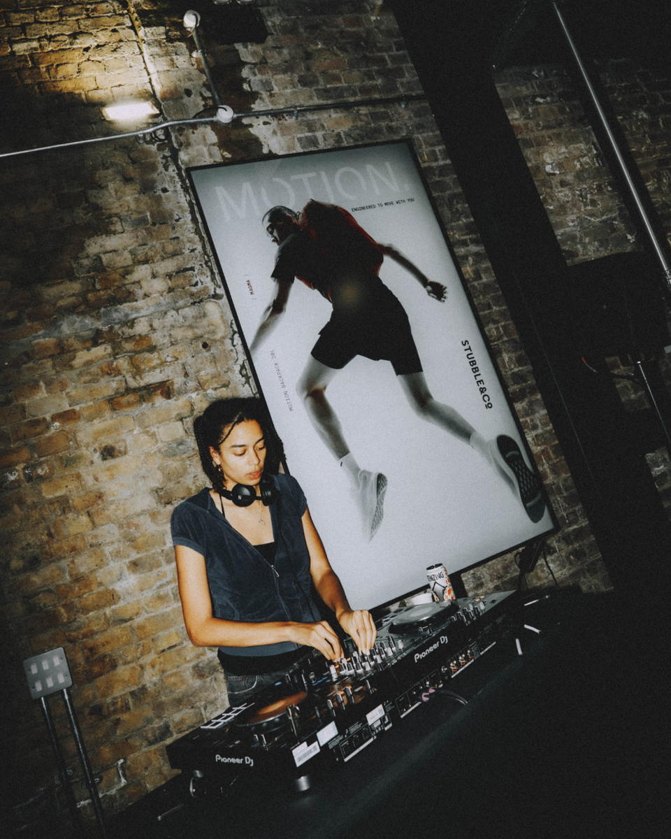 A woman djing at the Stubble & Co x Unsanctioned Athletics event