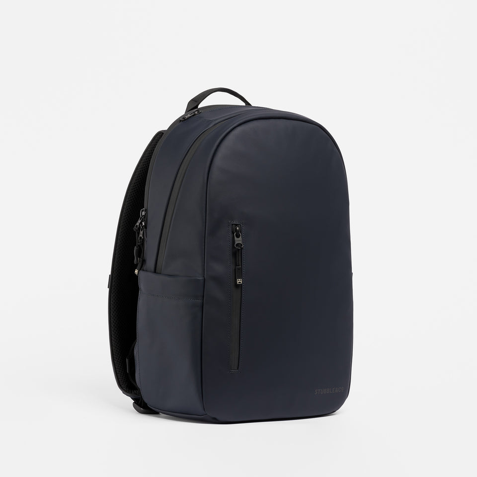 A studio shot of the Everyday Backpack 20L in Midnight Blue at an angle showing the front and side panels