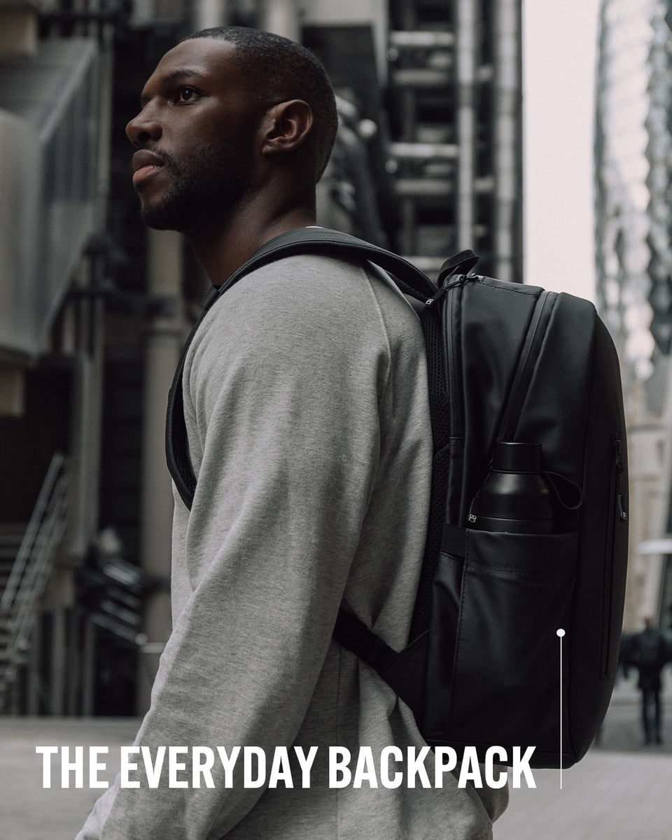 A man wearing an everyday backpack on his back with product name annotated