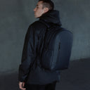 A man facing away wearing a Midnight Blue Everyday Backpack on his back