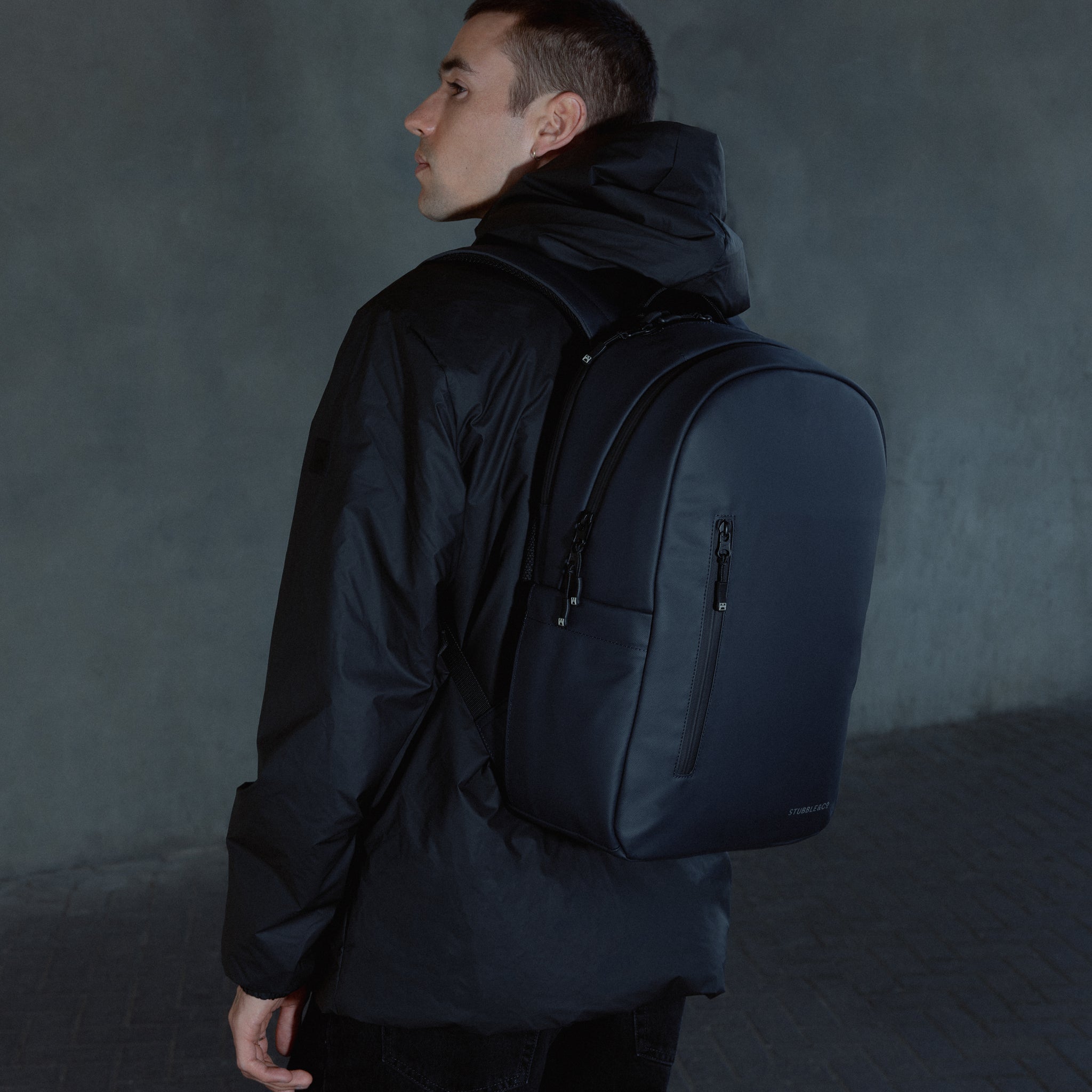 A man facing away wearing a Midnight Blue Everyday Backpack on his back