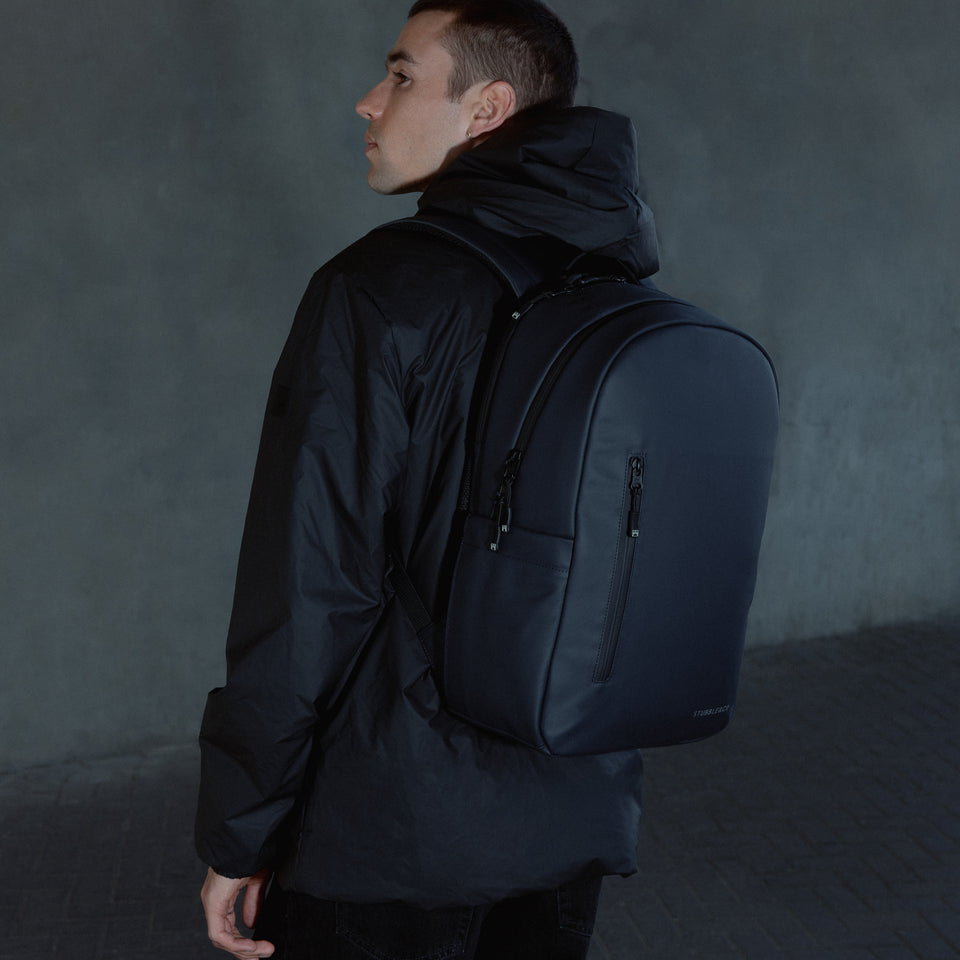 A man facing away wearing a Midnight Blue Everyday Backpack on his back