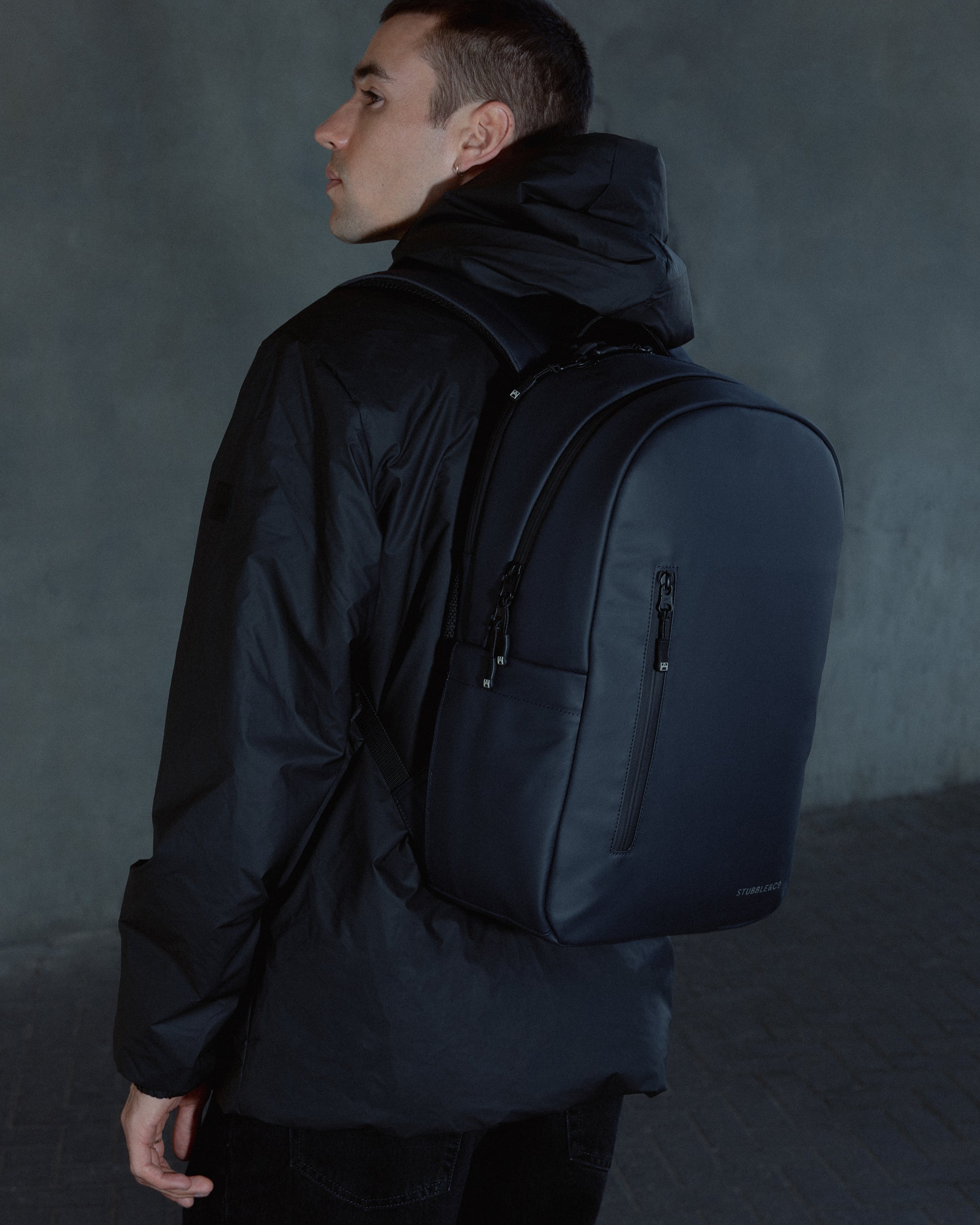 A man wearing an Everyday Backpack in Midnight Blue on his back
