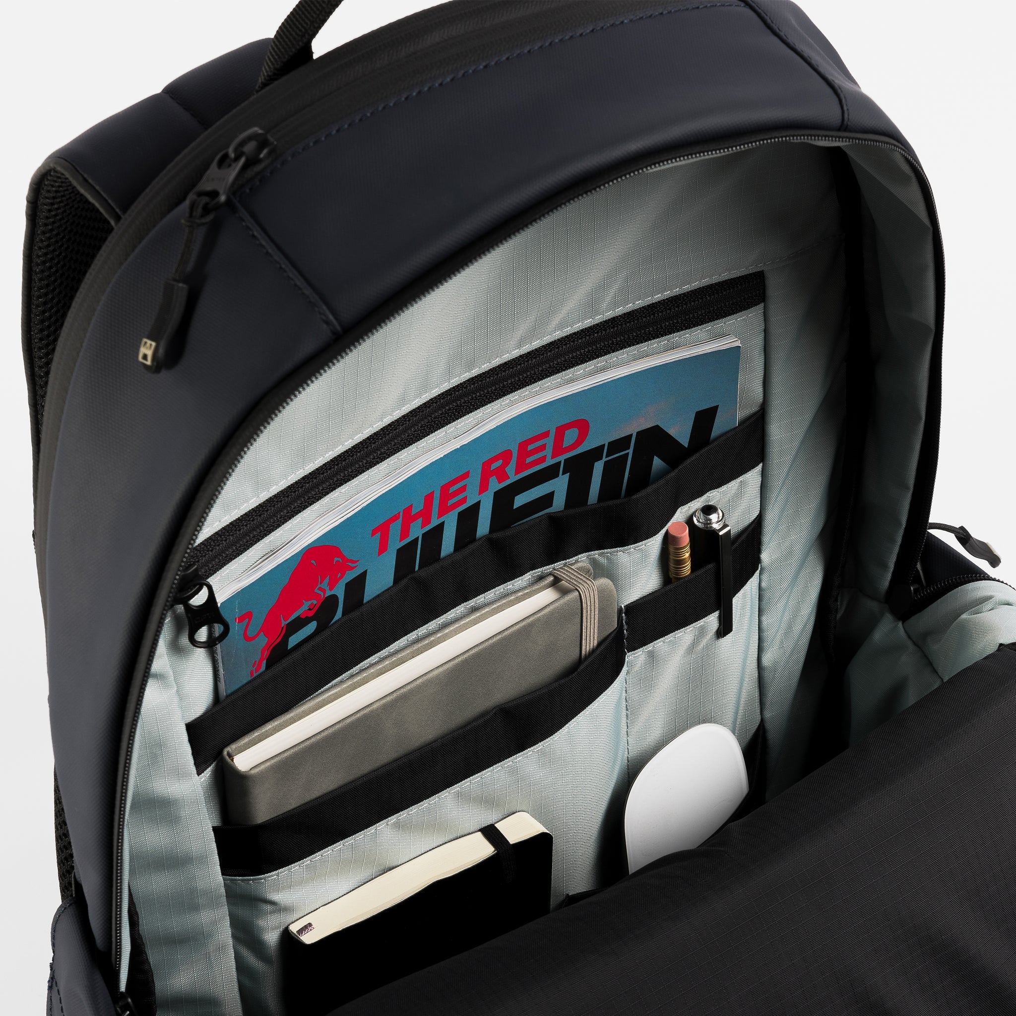 A studio shot of the interior organisation inside an Everyday Backpack in Midnight Blue