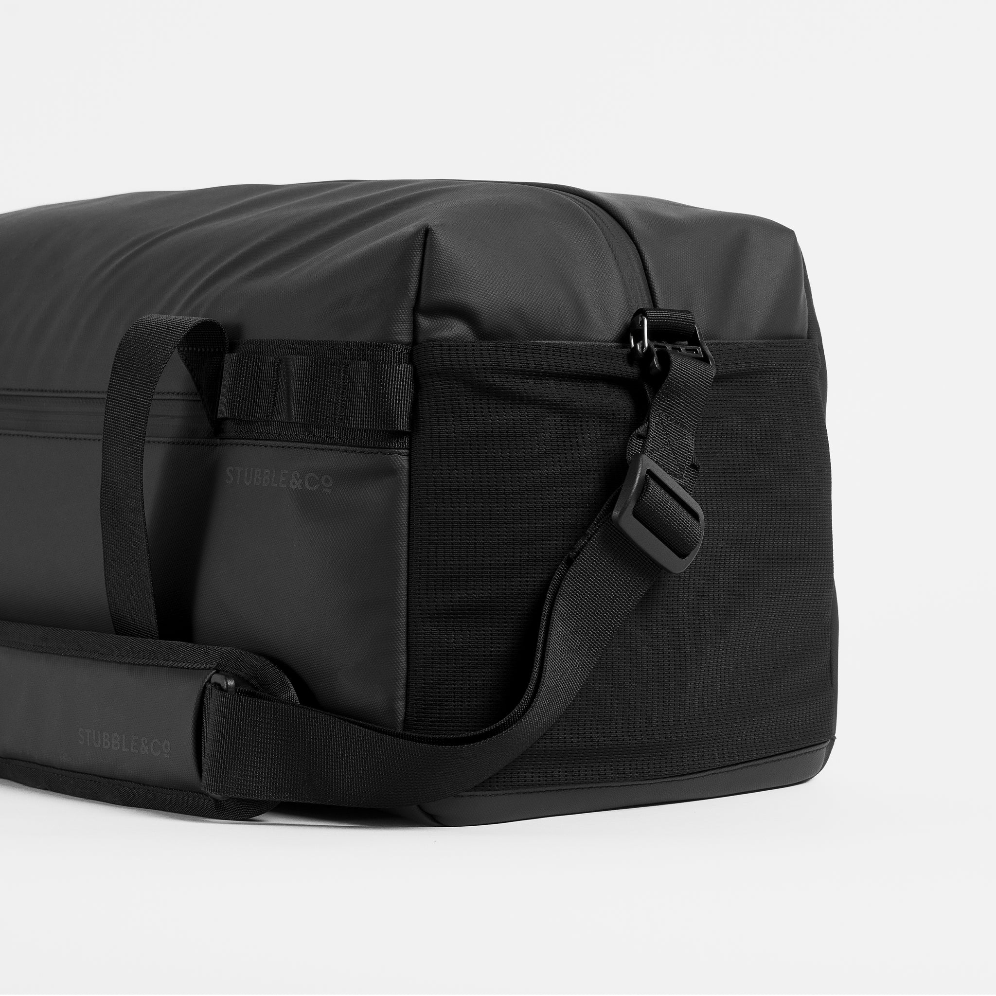 A studio shot of the mesh pocket and adjustable straps on the Gym Duffel 25L in All Black