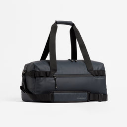A studio shot of the Gym Duffel 25L in Midnight Blue with the handle up