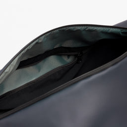 A studio shot of a close up of the interio zipped pocket on the Midnight Blue Gym Duffel 25L