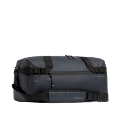 The Gym Duffel 25L in Midnight Blue with its shoulder strap