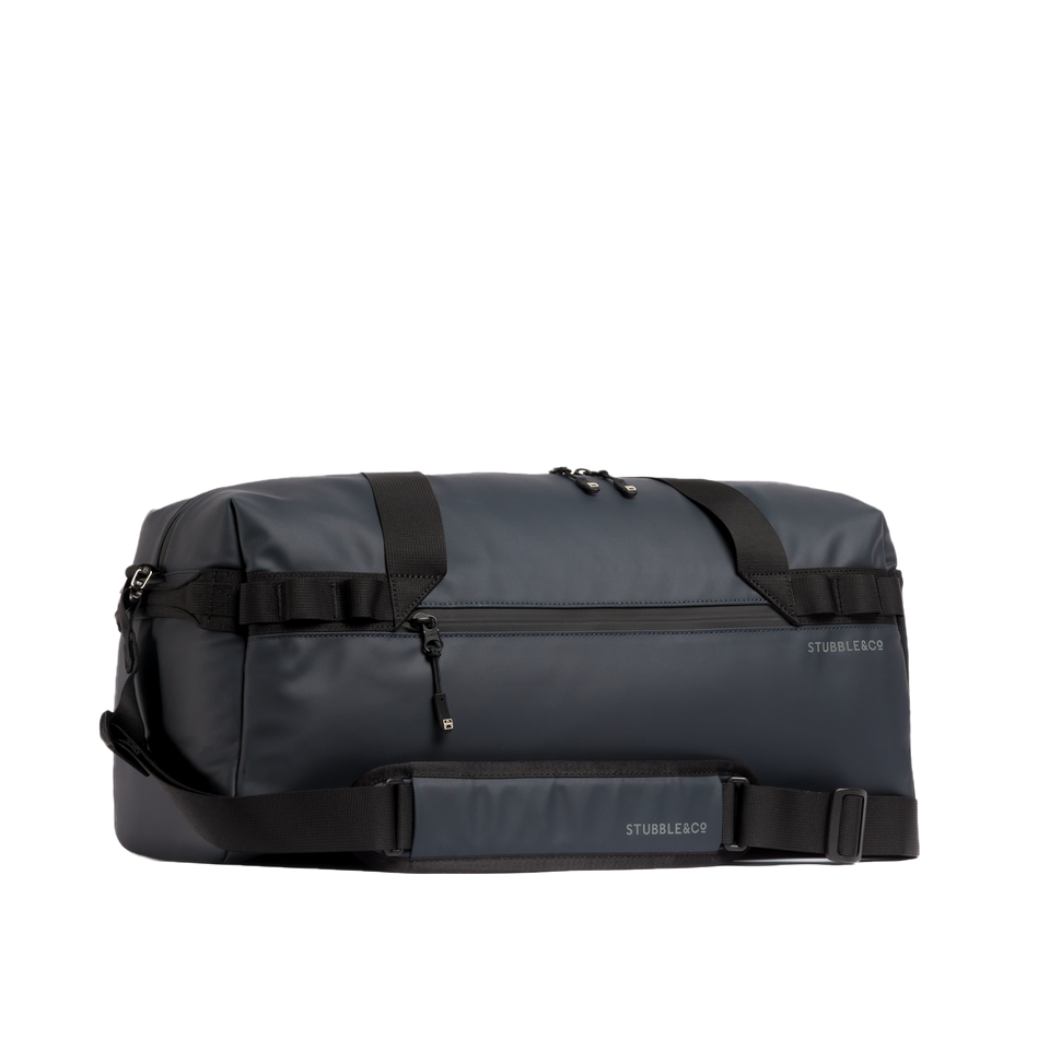 The Gym Duffel 25L in Midnight Blue with its shoulder strap