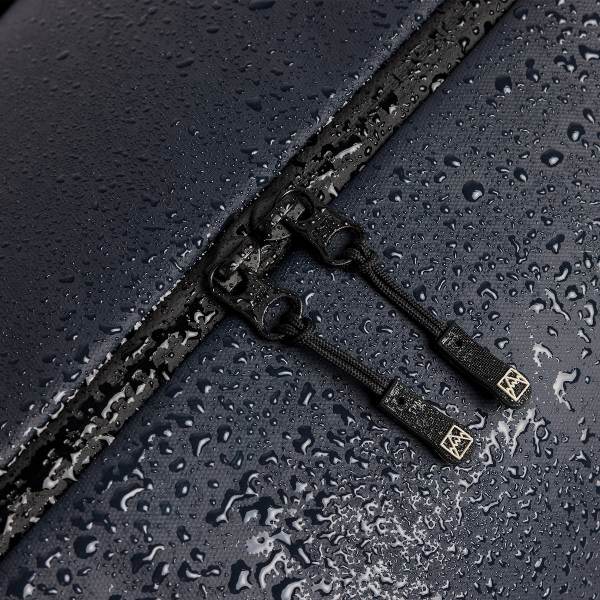 A studio shot showing the waterproof material on the Gym Duffel 25L in Midnight Blue