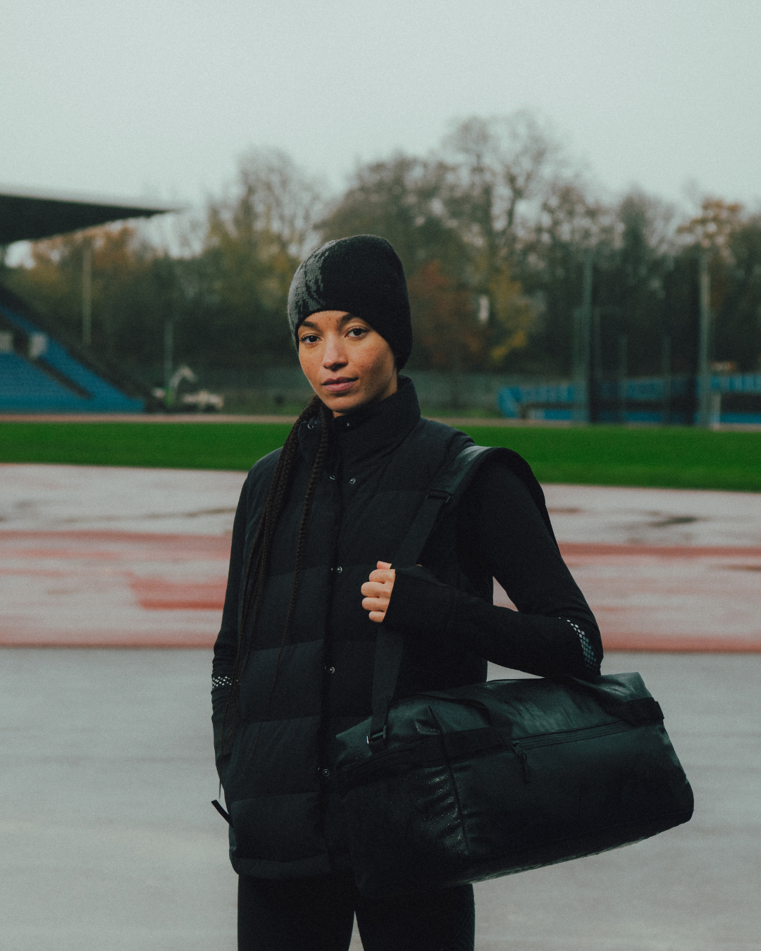 Hannah Williams at Crystal Palace race track holding Stubble & Co Gym Duffel