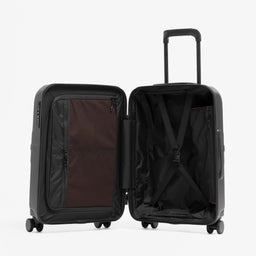 A studio shot of  the Hardshell 40L in All Black standing up and open showing the interior