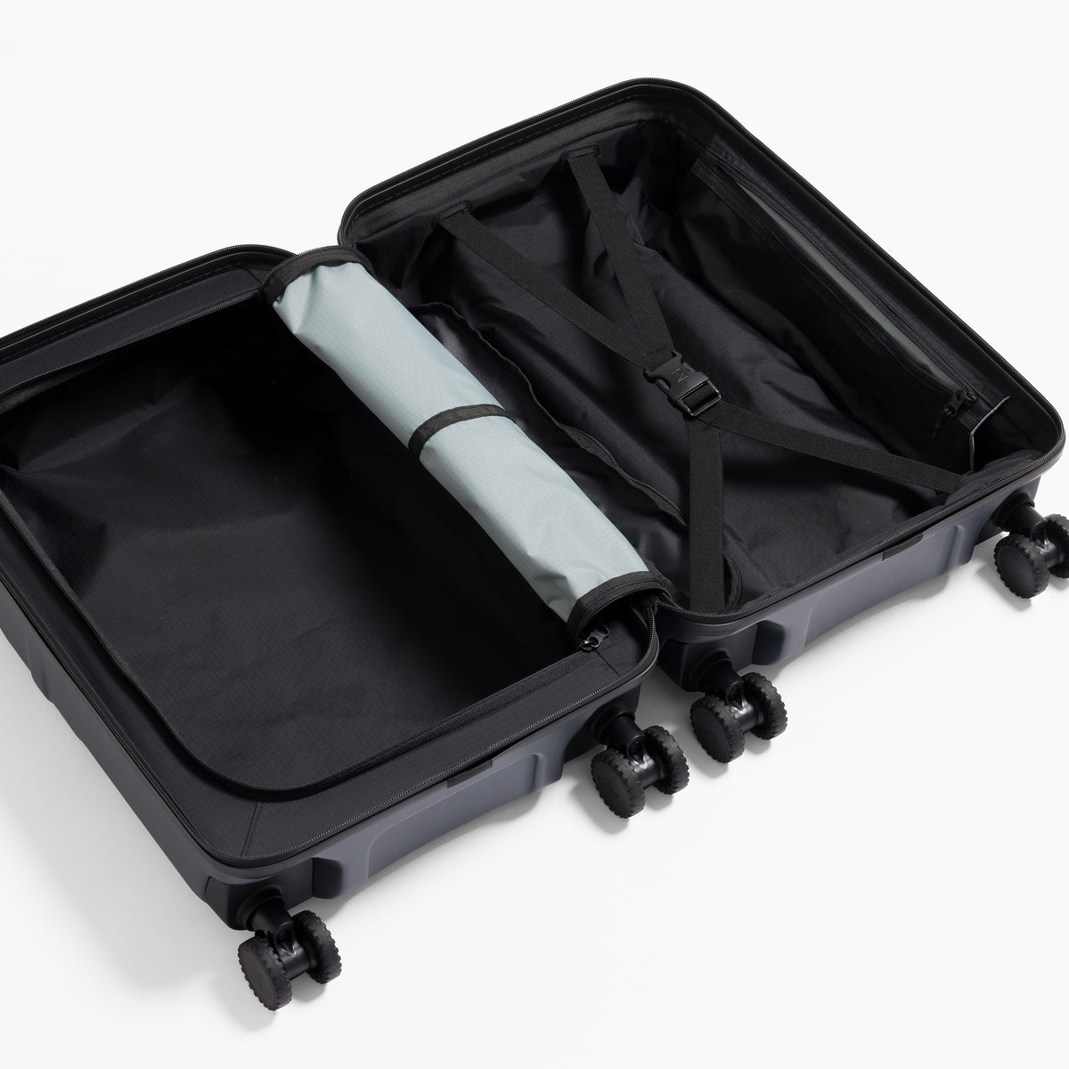 A studio shot of the interior organisation and compression strap in the Hardshell 40L in Midnight Blue