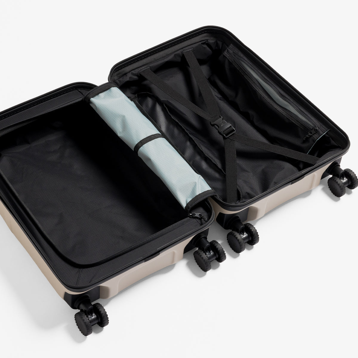 A studio shot of the inside and compression straps in the Hardshell 40L in Sand