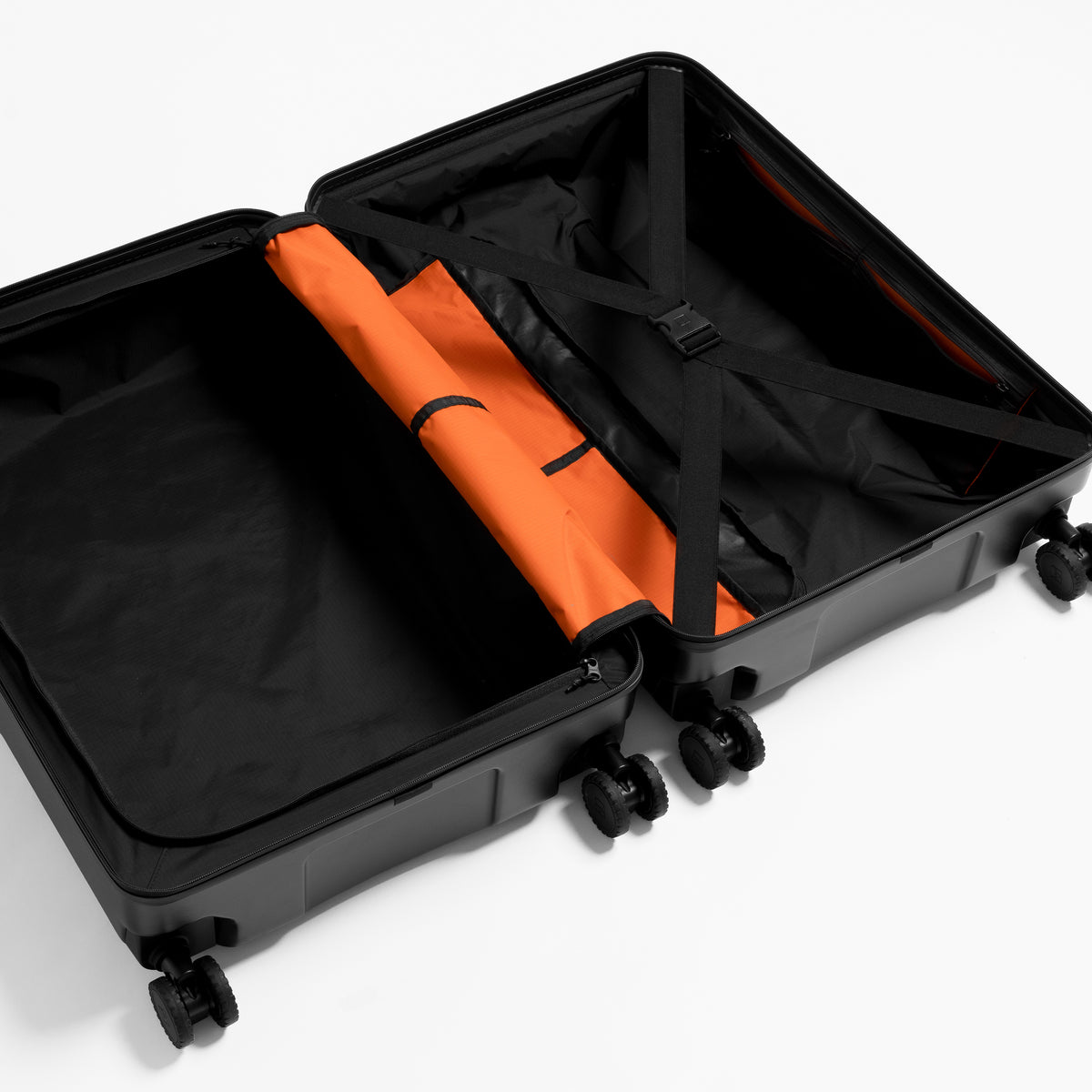 A studio shot of the interior and compression straps inside the Hardshell 95L in All Black
