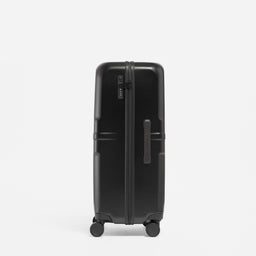 A studio shot of the side grab handle and lock on the Hardshell 95L in All Black