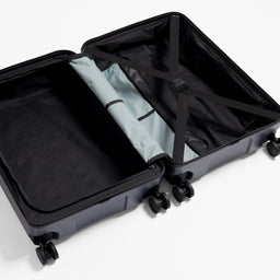 A studio shot of the inside an compression straps on the Hardshell 95L in Midnight Blue