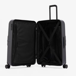 A studio shot of the Hardshell 95L in Midnight Blue standing and open