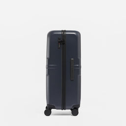 A studio shot of the side grab handle and lock on the Hardshell 95L in Midnight Blue