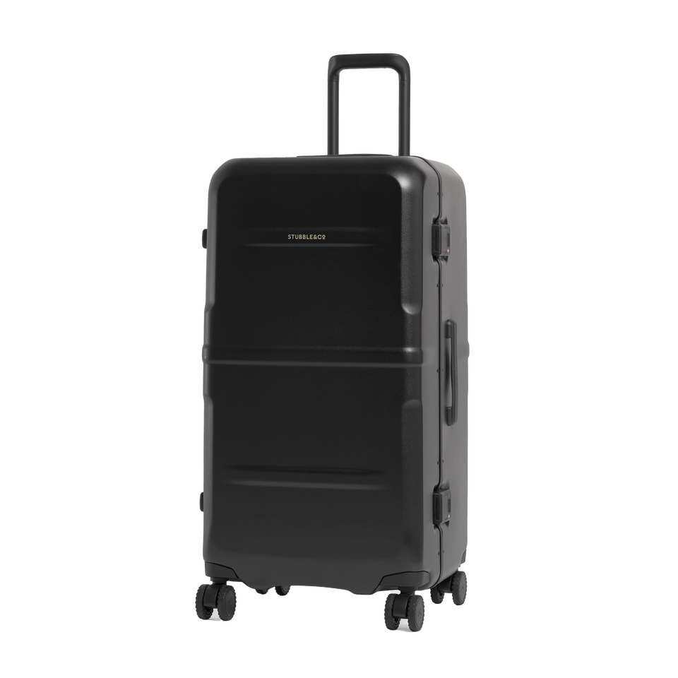 A black hard-shell spinner suitcase with an extended telescoping handle, shown from a three-quarter angle on a solid white background.