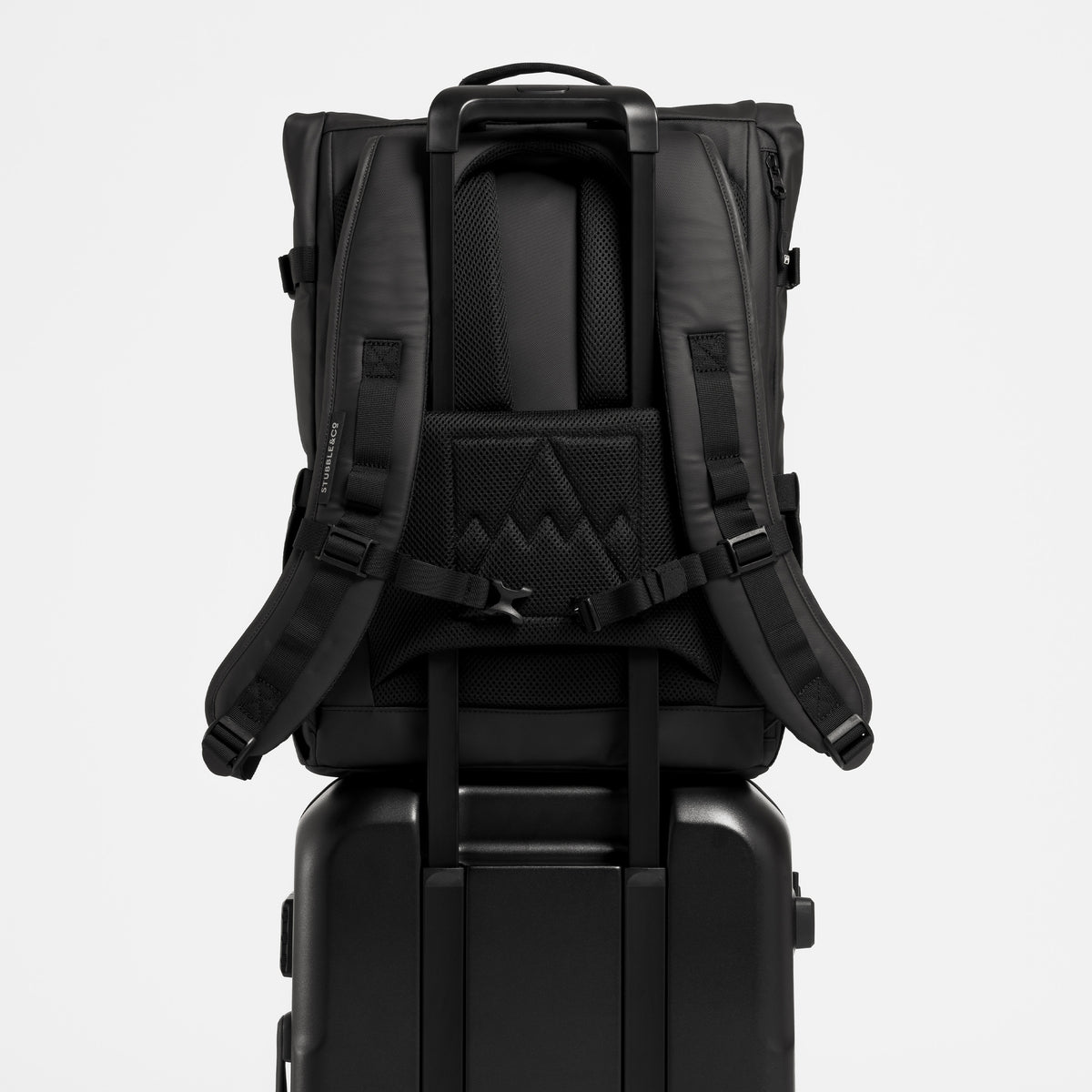 A Roll Top 20L on the handle of  the Hardshell 40L in All Black