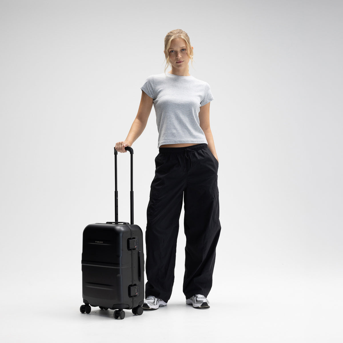A woman with the Hardshell Pro 40L in All Black