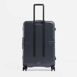 A studio shot of the back of the Hardshell Pro 95L in Midnight Blue