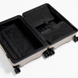 A studio shot of the inside and compression straps in the Hardshell Pro 95L in Sand
