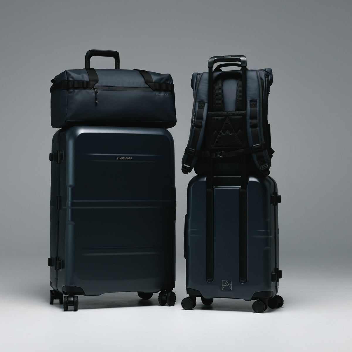 The Hardshell Range in Midnight Blue with the Gym Duffel and Roll Top on the trolley sleeve