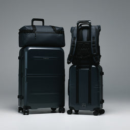 The Hardshell Range in Midnight Blue with the Gym Duffel and Roll Top on the trolley sleeve