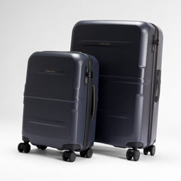 A studio shot of the Midnight Blue Hardshell suitcases standing next to eachother
