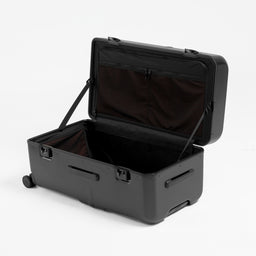 A studio shot of the clamshell opening on the Hardshell Pro Trunk 100L in All Black