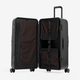 A studio shot of the Hardshell Pro Trunk 100L in All Black standing and open