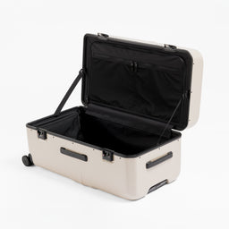 A studio shot of the clamshell opening on the Hardshell Pro Trunk 100L in Sand