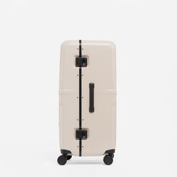 A studio shot of the side and grab handles on the Hardshell Pro Trunk 100L in Sand