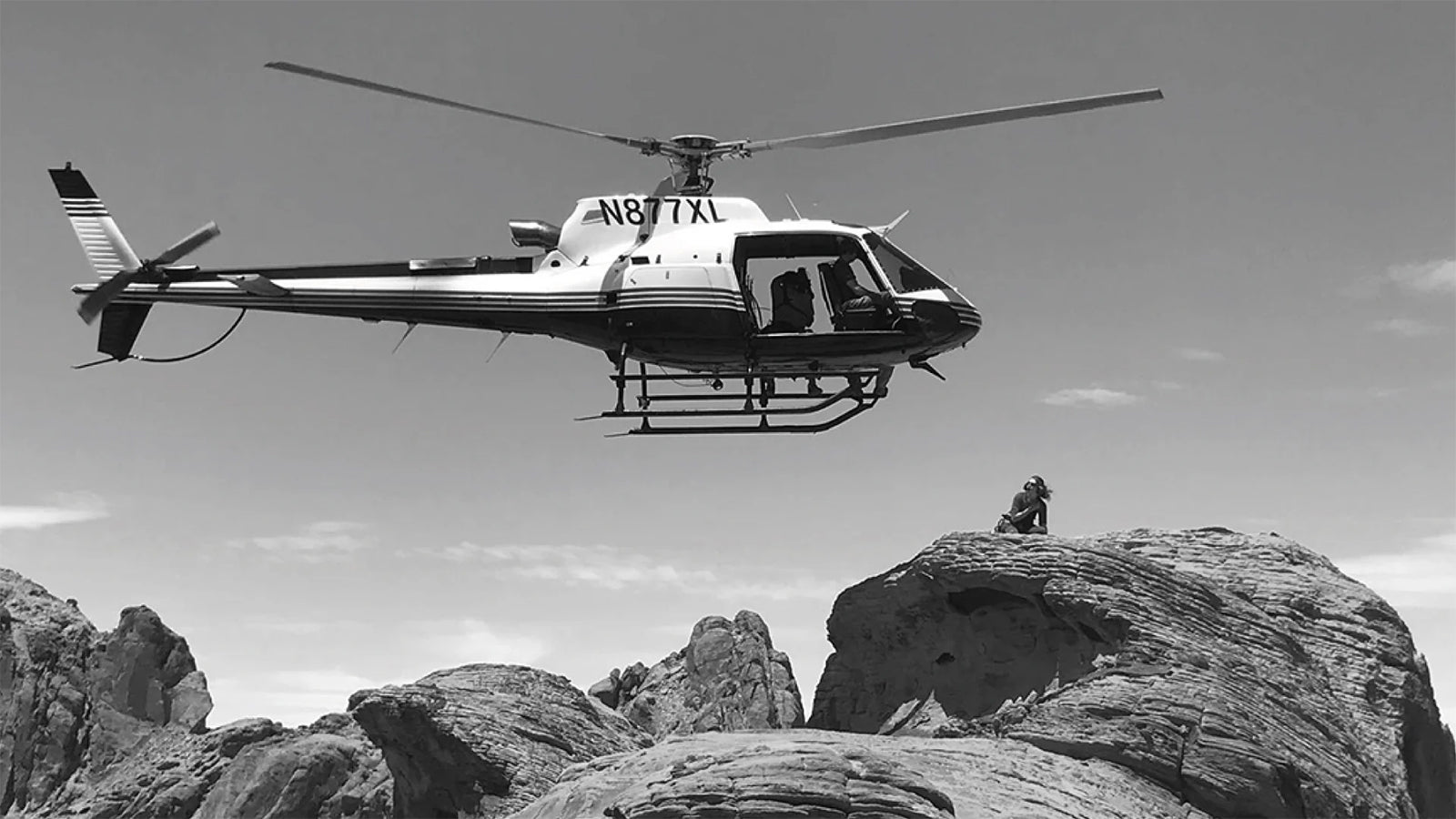 A black and white shot of a helicopter landing
