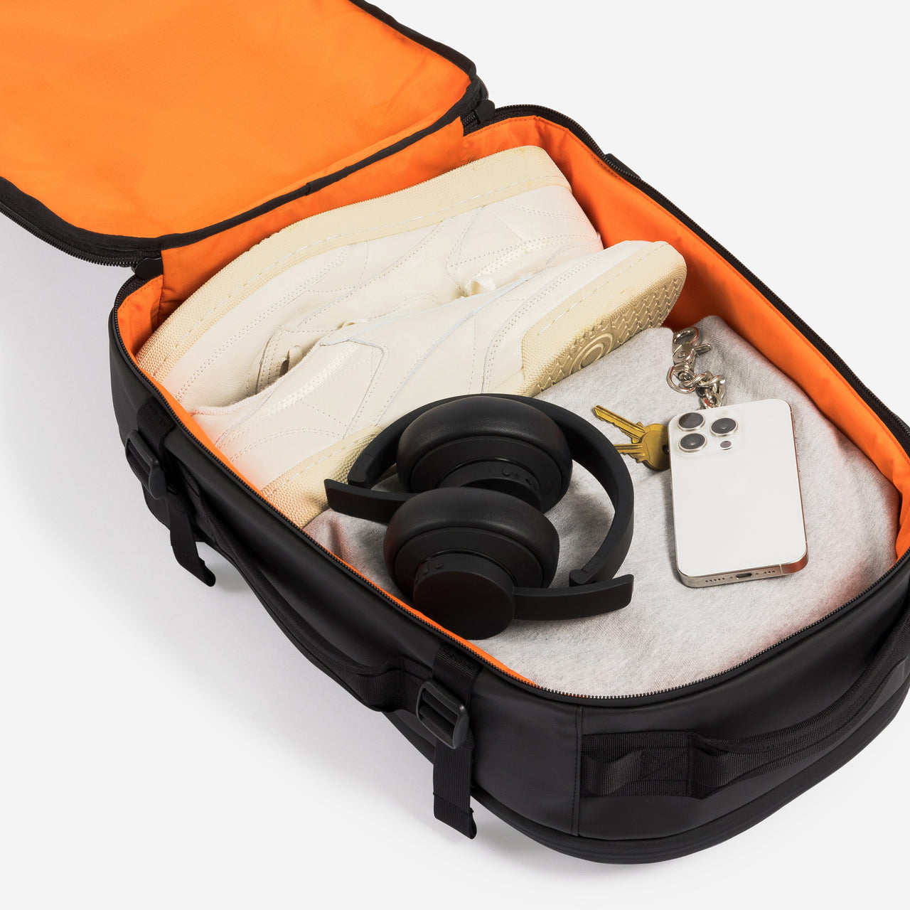 A studio shot of the packed interior of the Hybrid Backpack 20L in All Black
