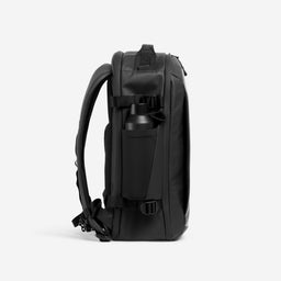 A studio shot of the side bottle pocket on the Hybrid Backpack 20L in All Black