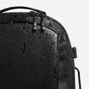 A studio shot of the waterproof material on the Hybrid Backpack 20L in All Black