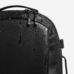 A studio shot of the waterproof material on the Hybrid Backpack 20L in All Black