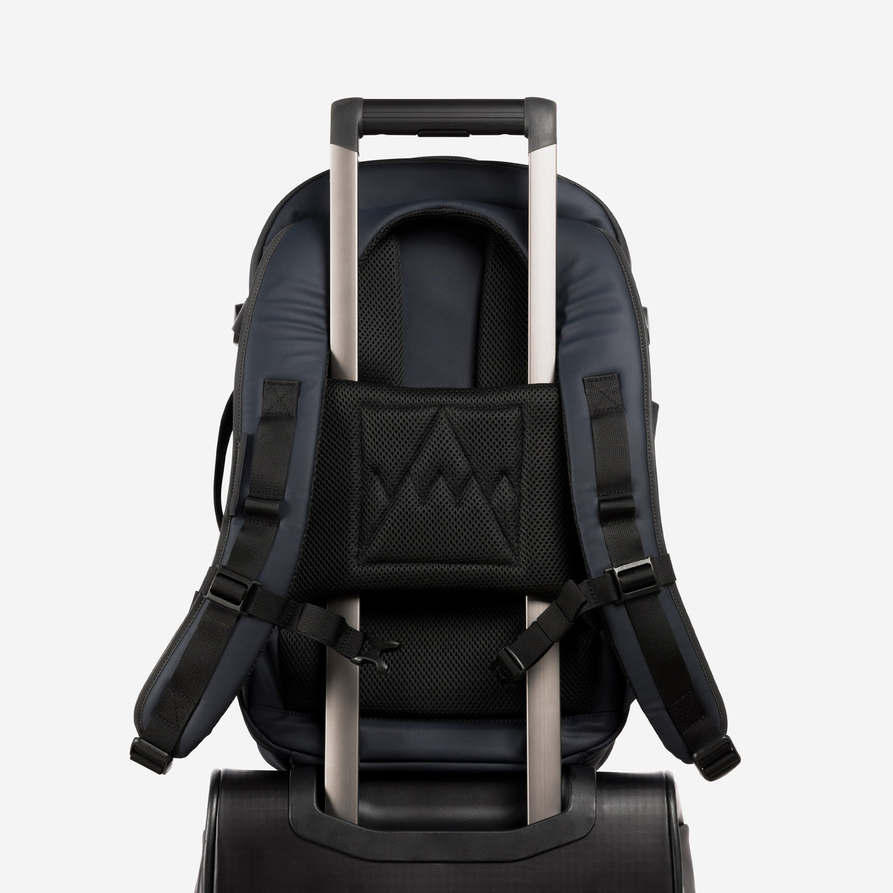 A studio shot of the trolley sleeve on a Hybrid Backpack 20L in Midnight Blue