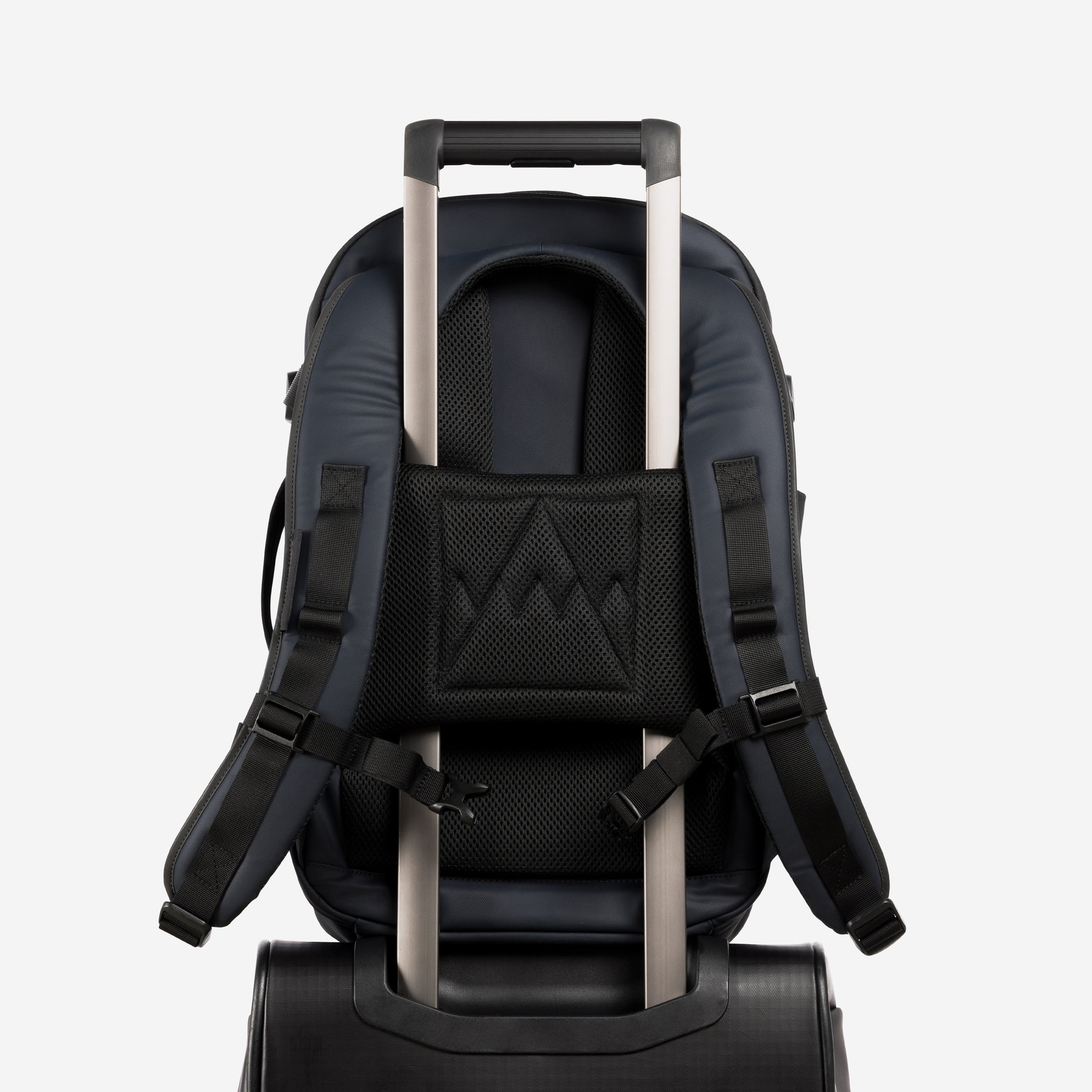 A studio shot of the trolley sleeve on a Hybrid Backpack 20L in Midnight Blue
