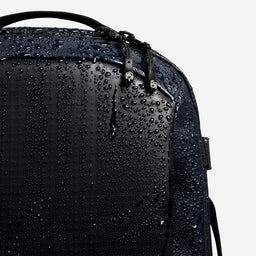 A studio shot of the waterproof material on the Hybrid Backpack 20L in Midnight Blue