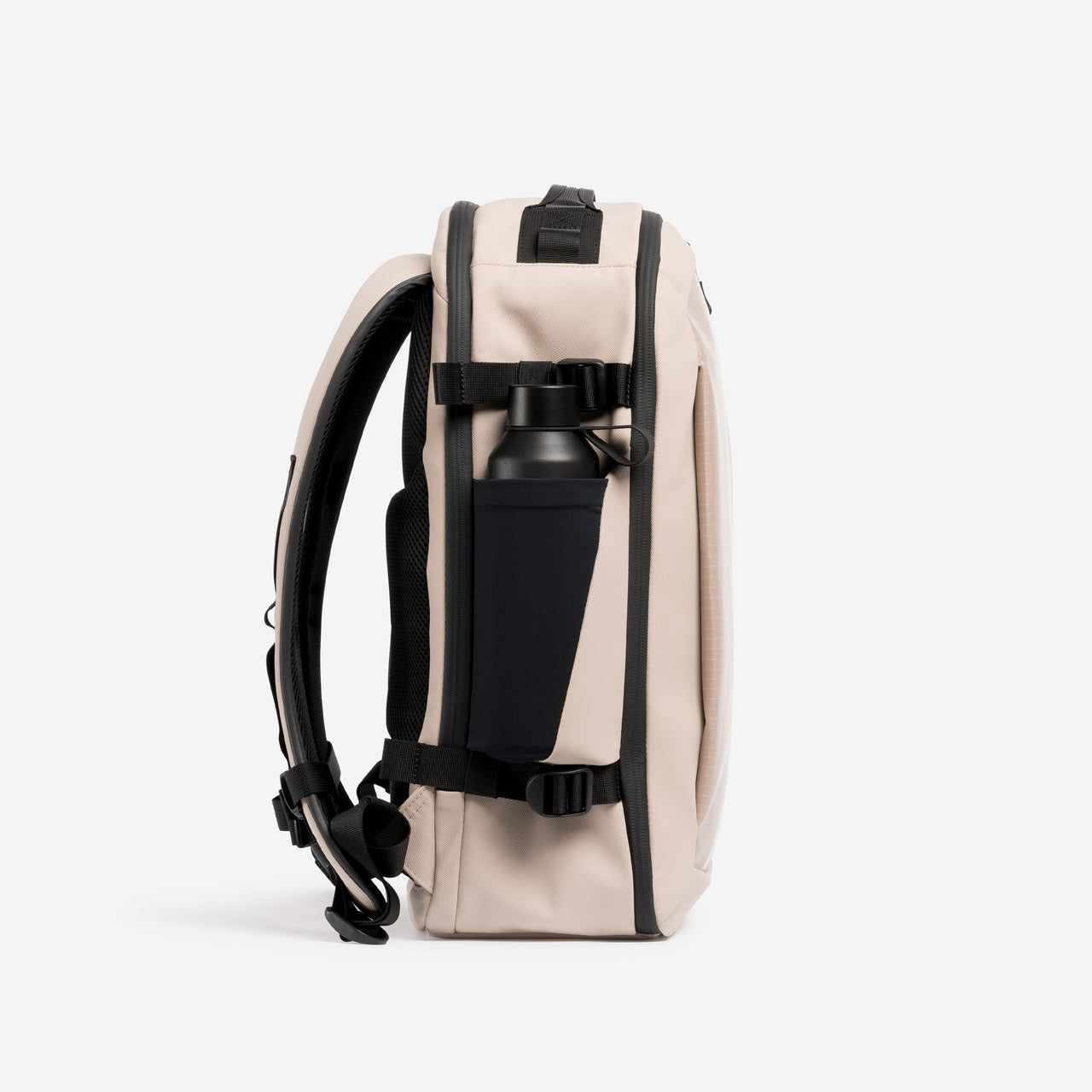A studio shot of the side bottle pocket on the Hybrid Backpack 20L in Sand