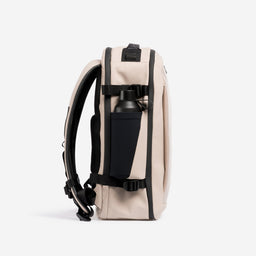 A studio shot of the side bottle pocket on the Hybrid Backpack 20L in Sand
