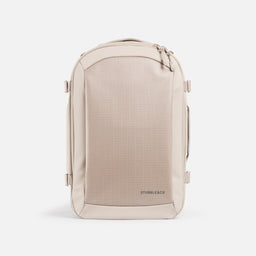 A studio shot of the elasticated bottle pocket on the side of the Hybrid Backpack 20L in Tonal Sand