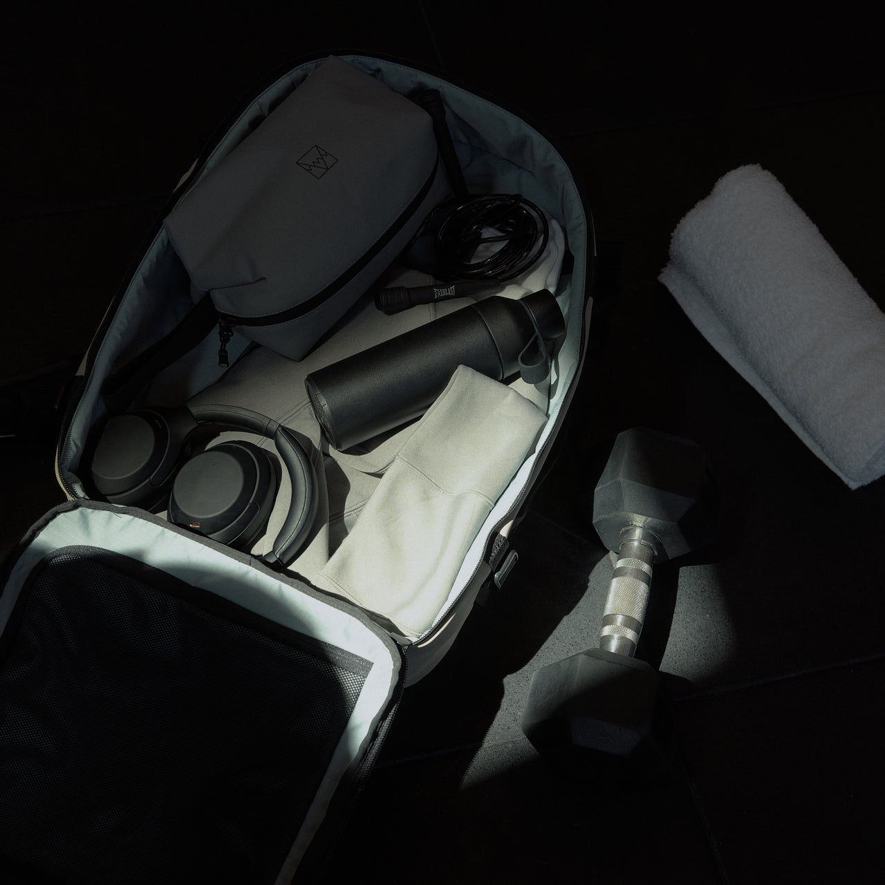 A packed interior of the Hybrid Backpack 30L in Sand, packed with gym accesories